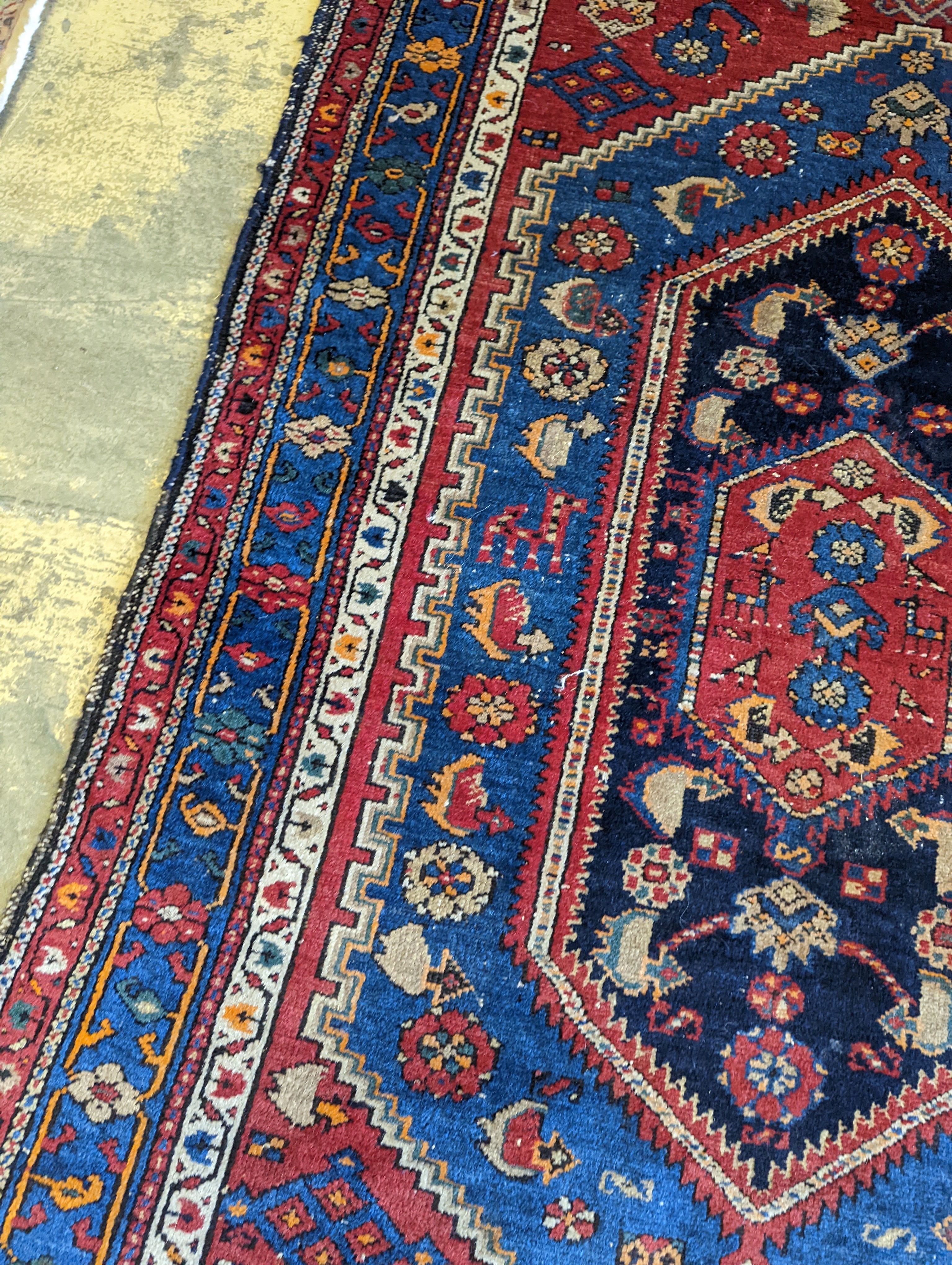 A Caucasian brick red ground rug, 194 x 130cm